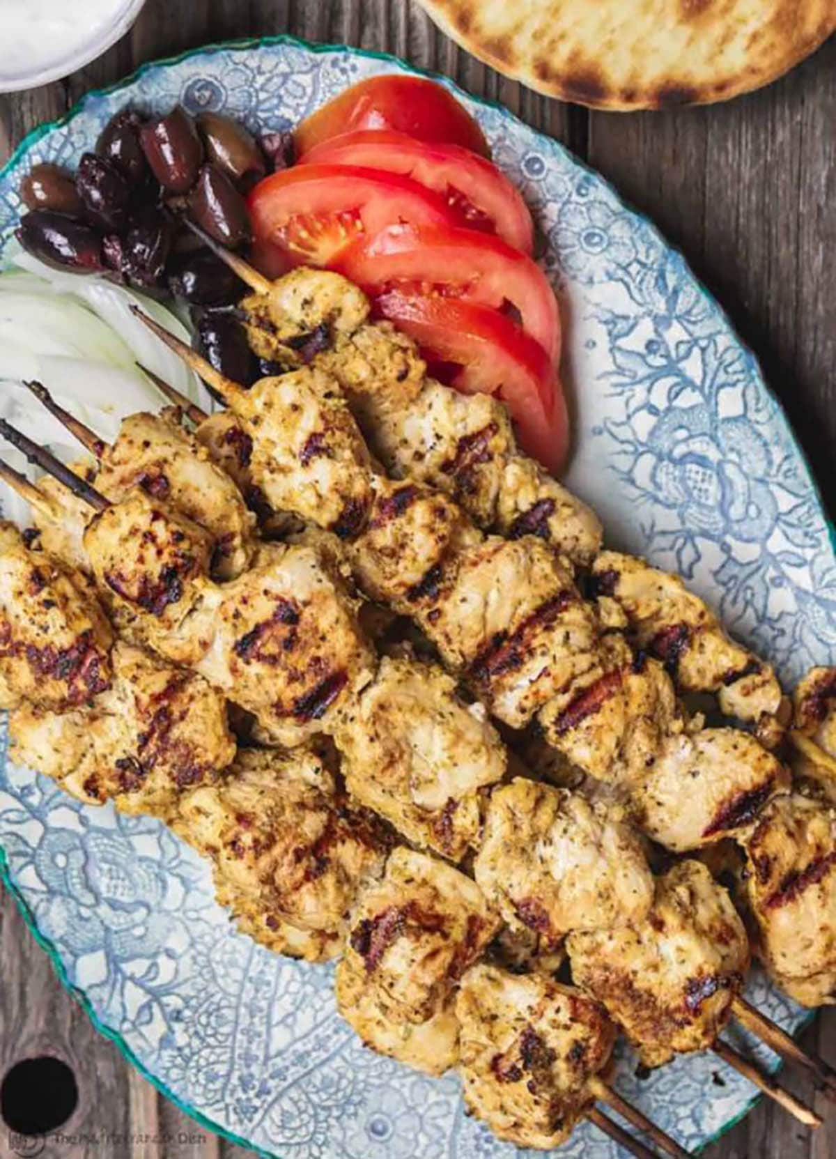 Chicken Souvlaki with tomatoes black olives and white onions