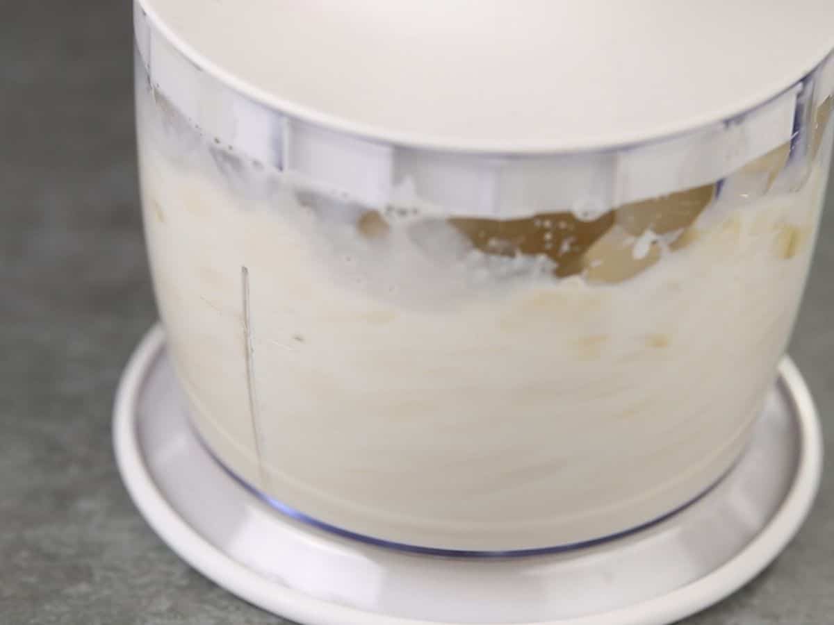 Food processor filled with banana ice cream mixture