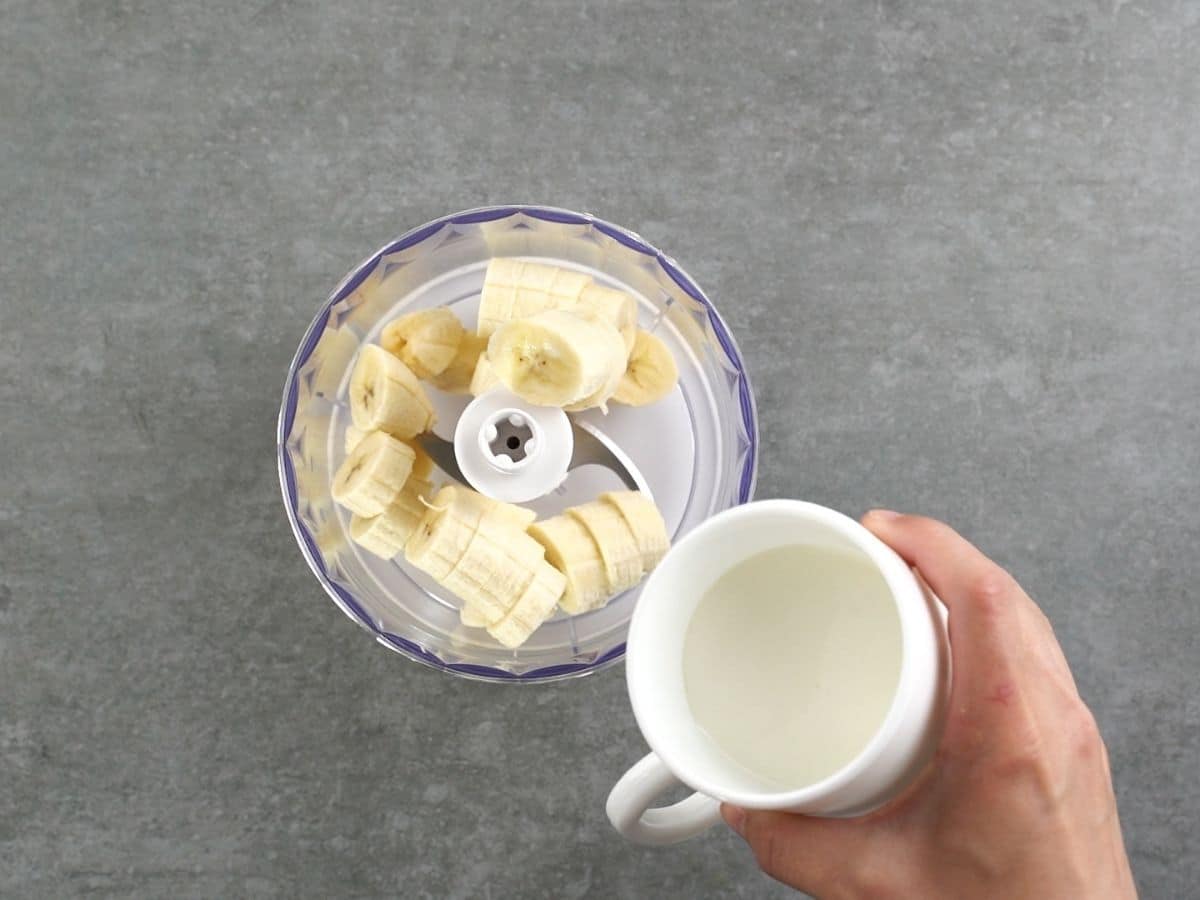 Adding milk to bananas in food processor