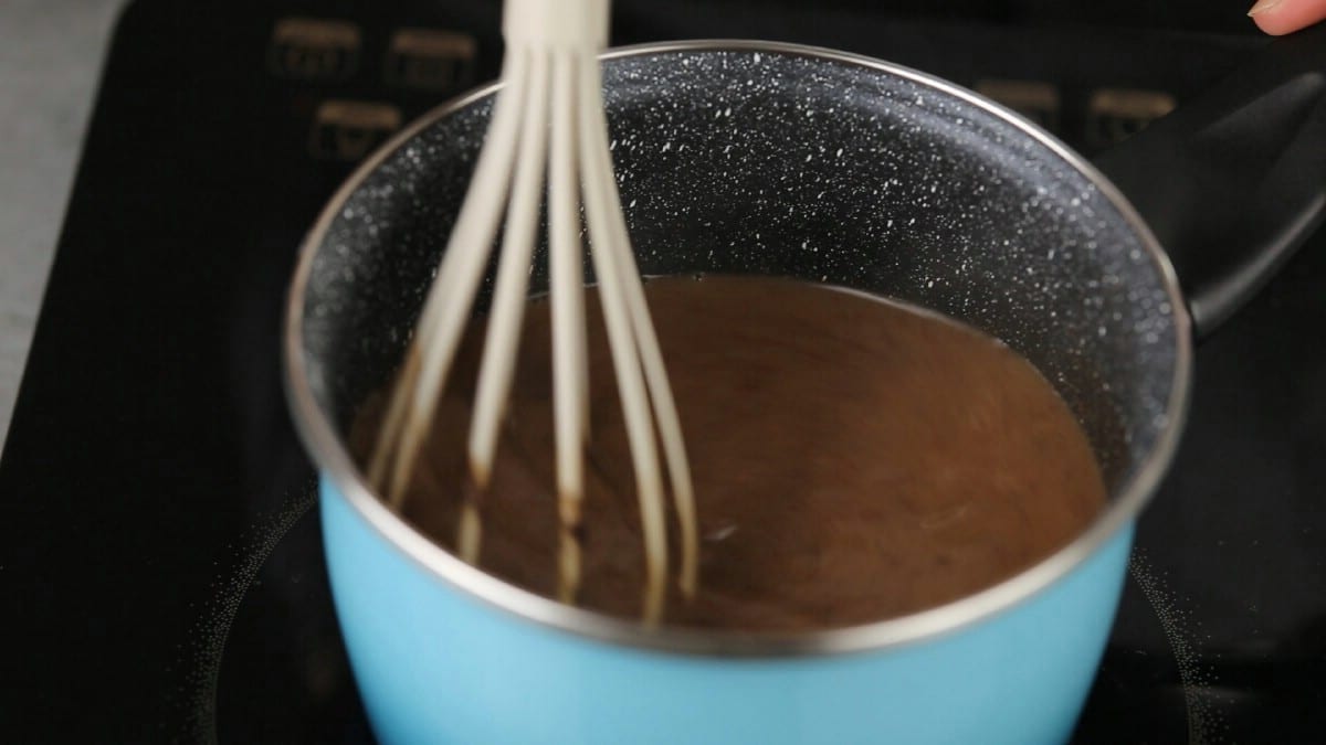 Whisk in chocolate mixture in teal pot