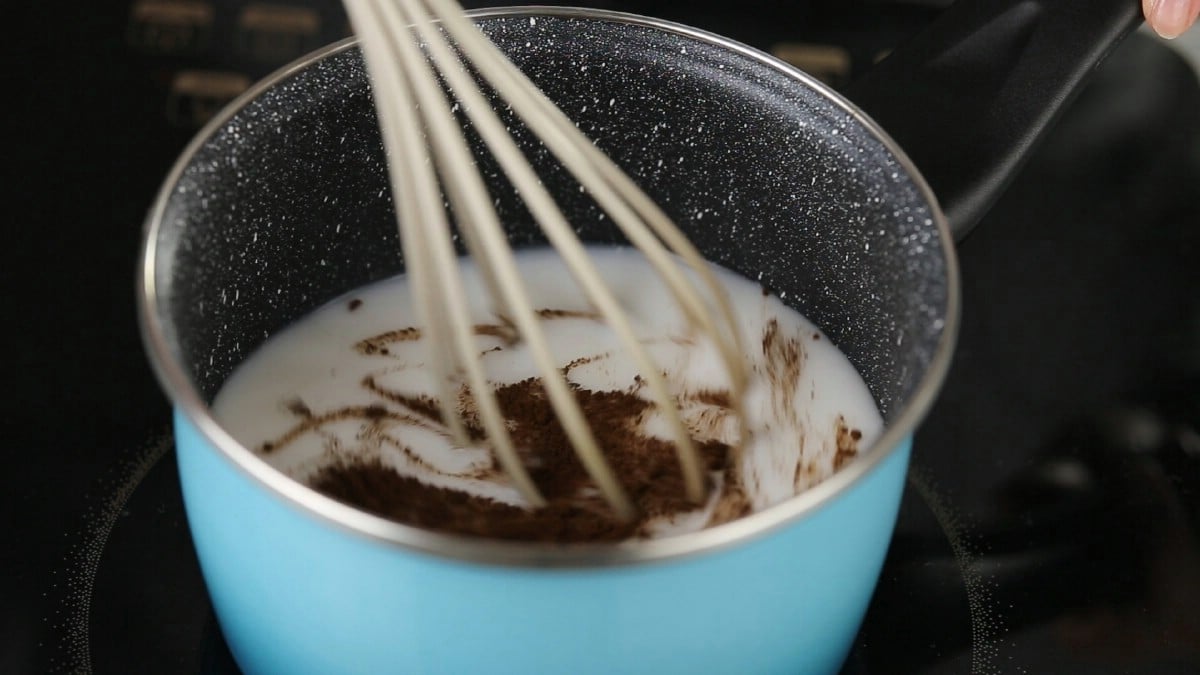Whisk in light blue pan with milk and chocolate
