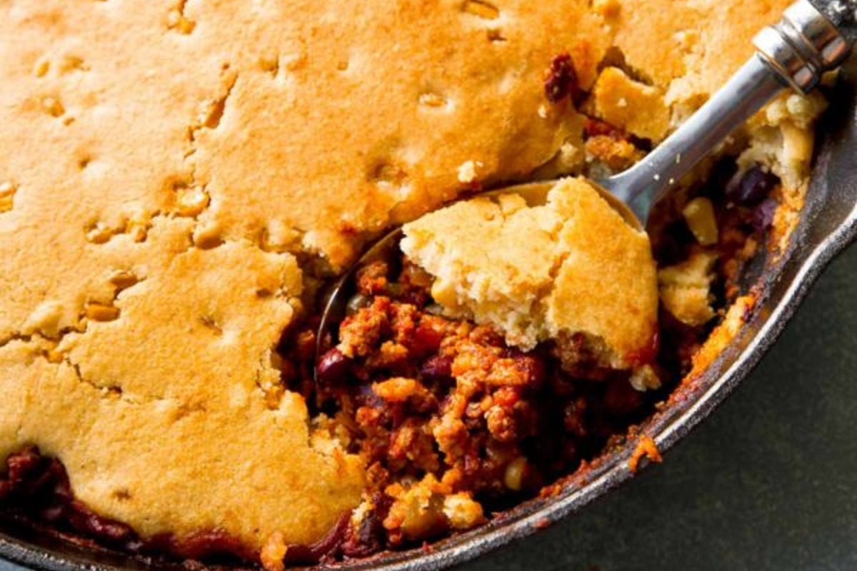 Spoon scooping Cornbread Topped Skillet Chilli