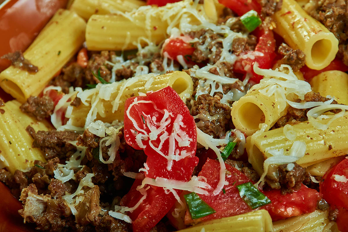 Cowboy Pasta Salad loaded with ground beef, bacon, sweet corn, black beans, tomatoes, and cheese smothered in tangy, creamy southwest barbecue sauce.