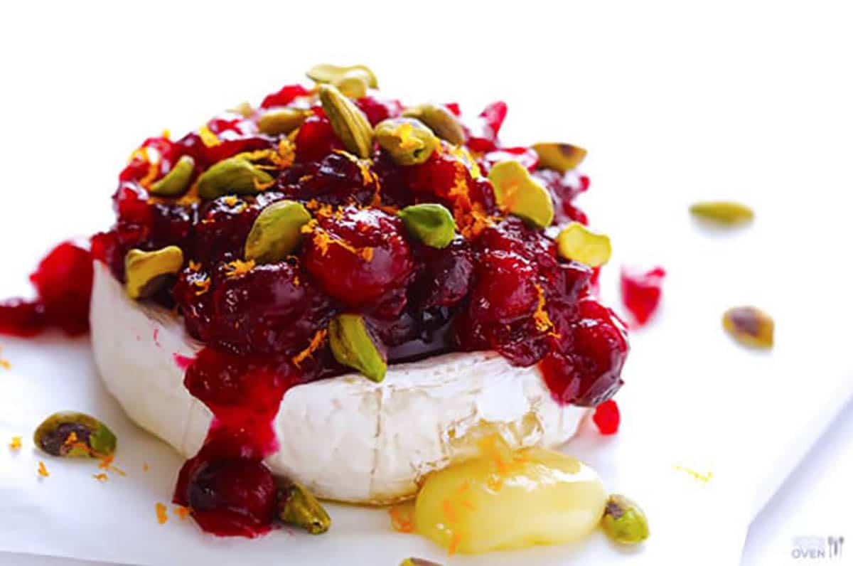 Cranberry And Pestachio Baked Brie topped with orange zest and pestachios