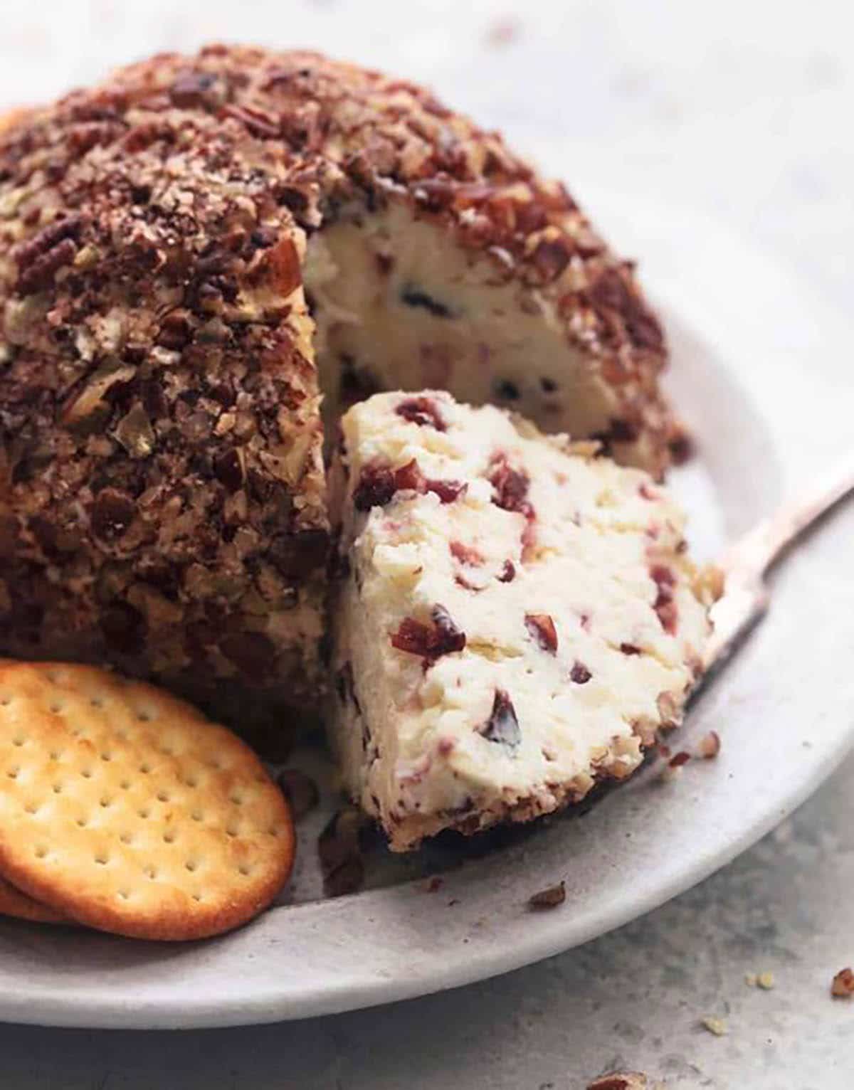 Cranberry pecan cheese ball served with crackers on the side