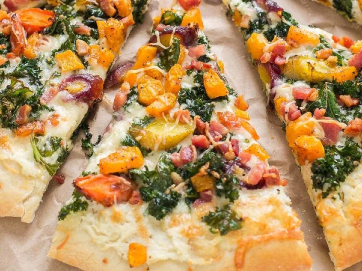 Fall harvest pizza with roasted fall vegetables like butternut squash and carrots