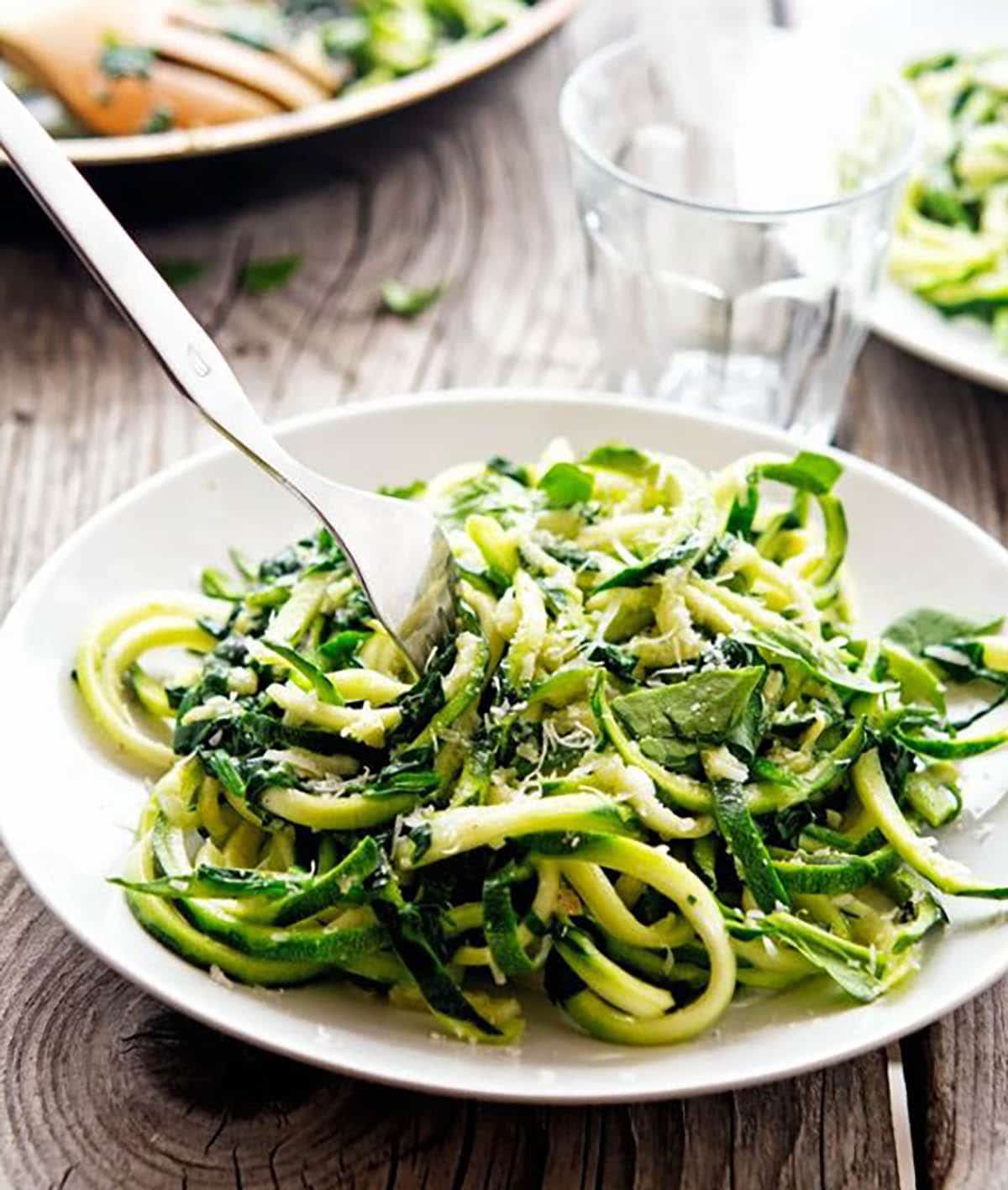 Garlic Butter Zoodles with Herbs and Sprinkled with Grated Parmesan Cheese
