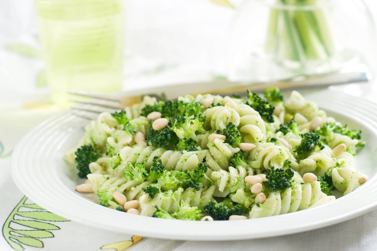 Green Goddess Pasta Salad made with DeLallo Gemelli Pasta, Basil Pesto, Peas, Asparagus, Chickpeas, nuts and chopped chives.