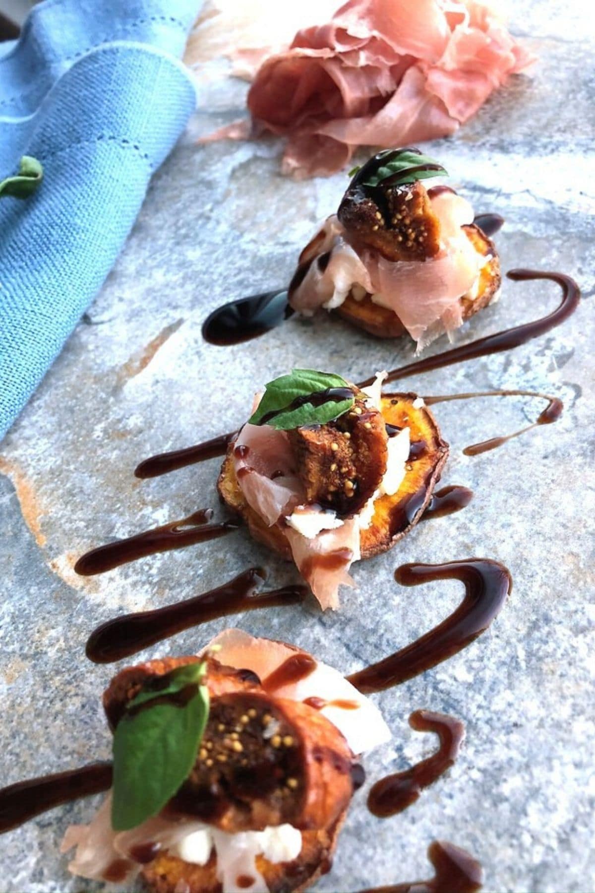 sweet potato crostini with glaze over top on parchment paper