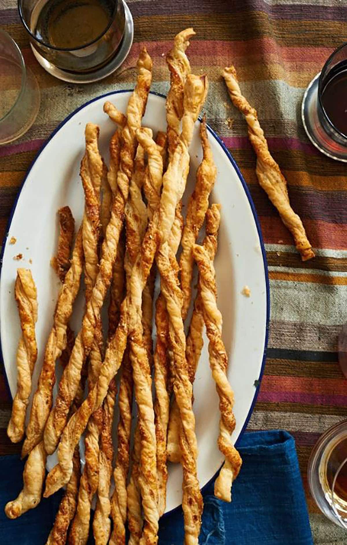 Homemade twisted Cheese Straws on a plate