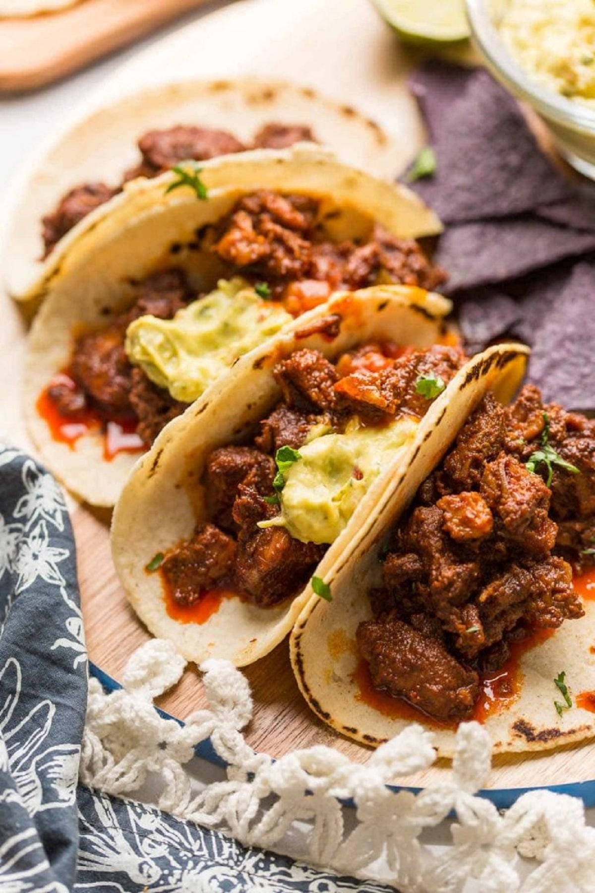 Instant pot adobada tacos on a wood tray