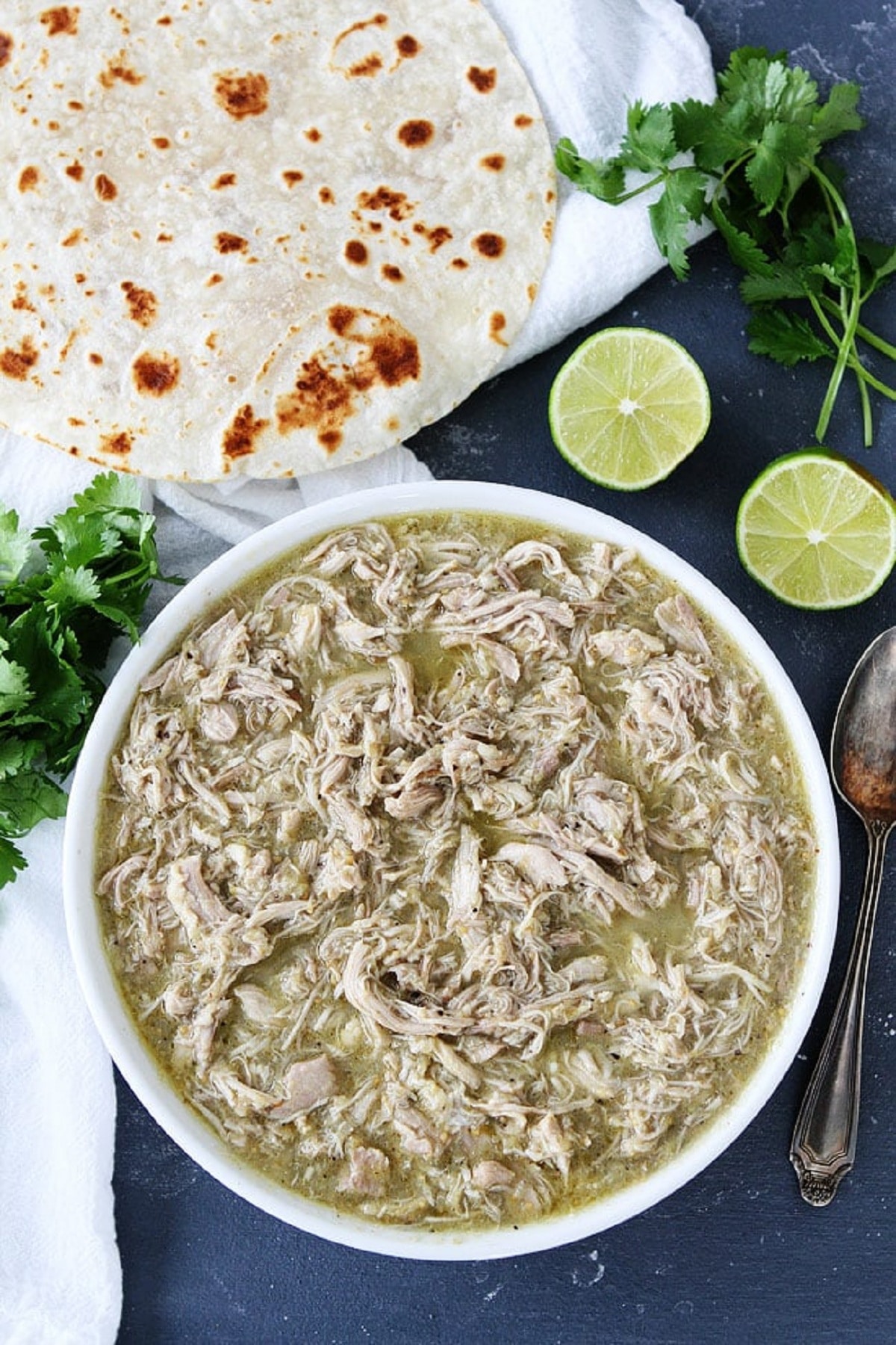 Instant pot chicken chile verde served with pita and coriander on the side