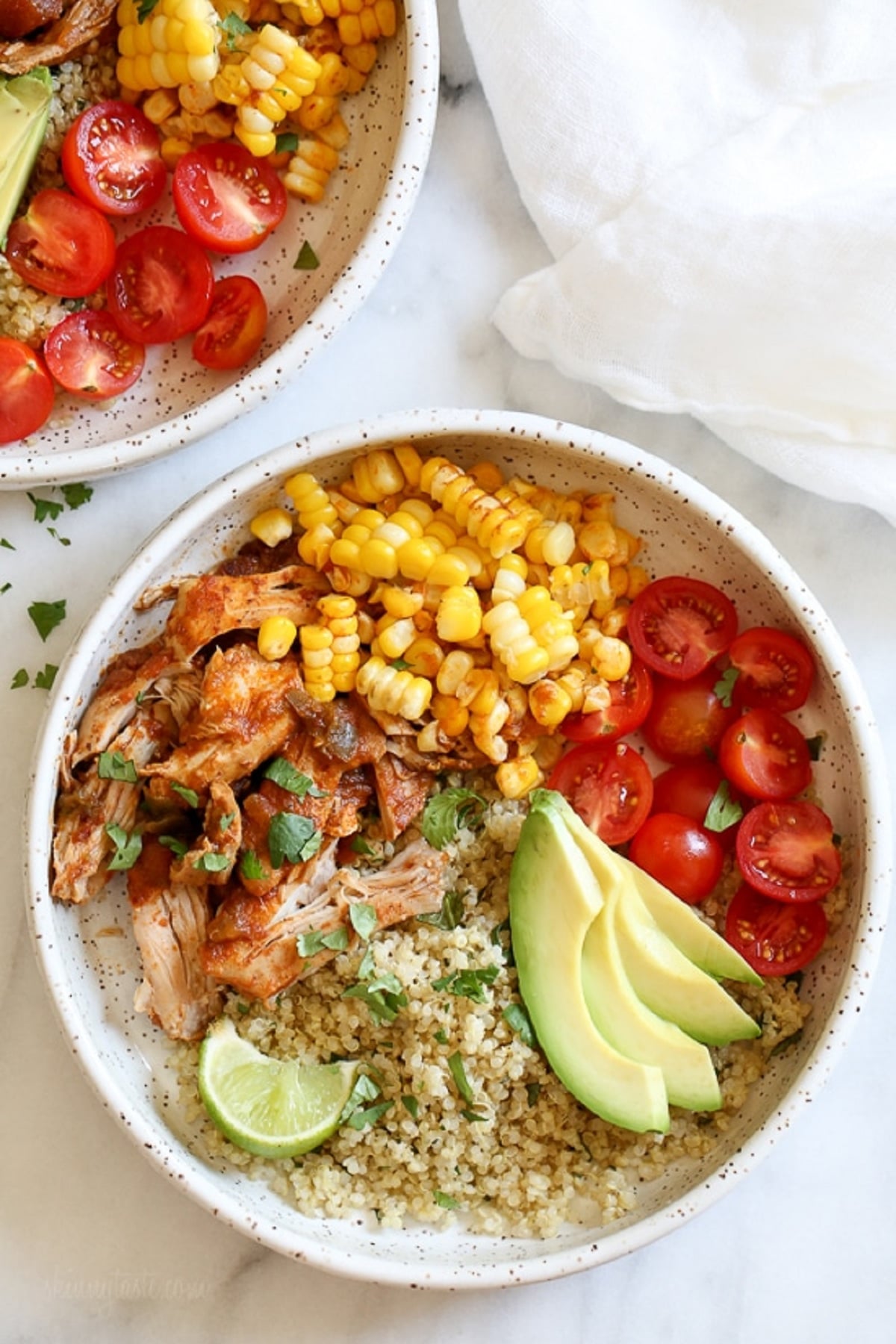 Instant pot chipotle chicken bowls with cilantro lime quinoa, cherry tomatoes and sliced avocado