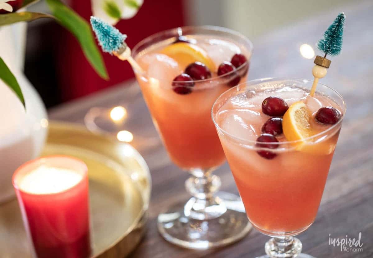 Naughty But Nice Christmas Cocktail topped with an orange slice and pomegranate seeds