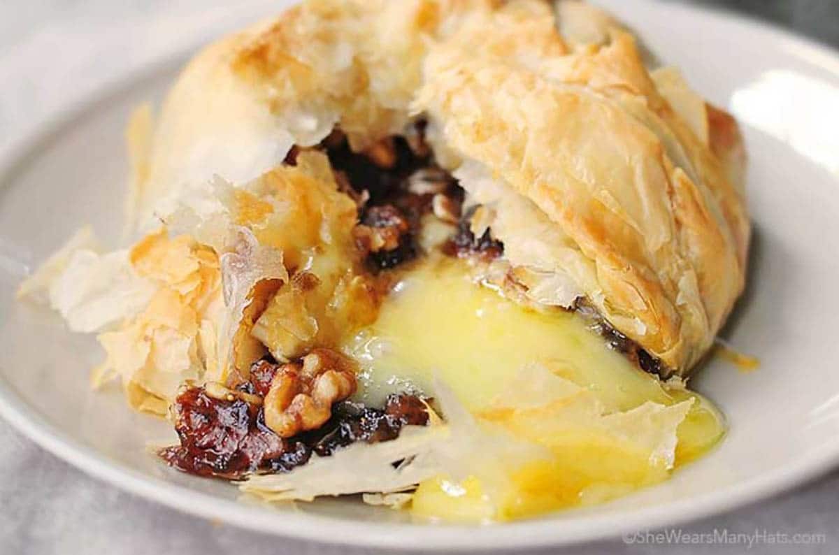 Phyllo baked brie with figs and walnuts on a plate