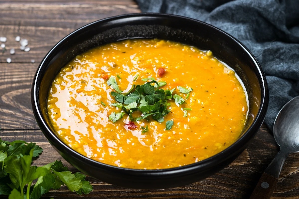 Red Lentil and Coconut Soup topped with chopped kale