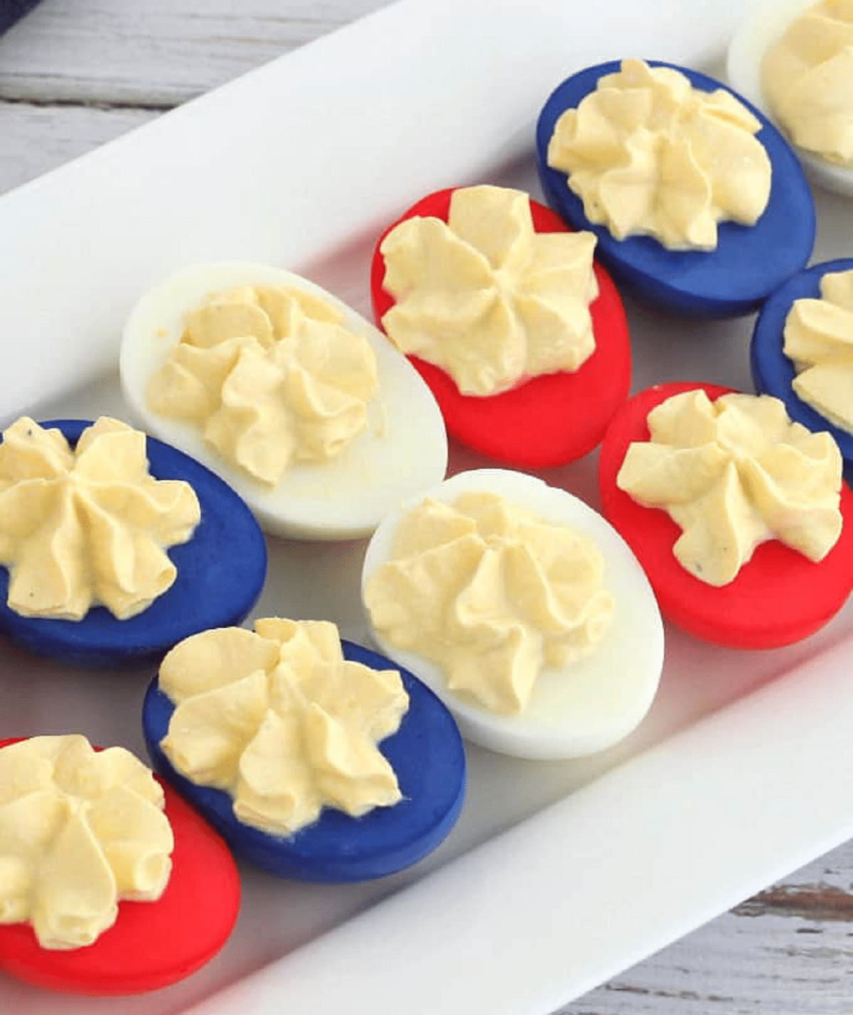 Deviled eggs dyed red and blue on platter