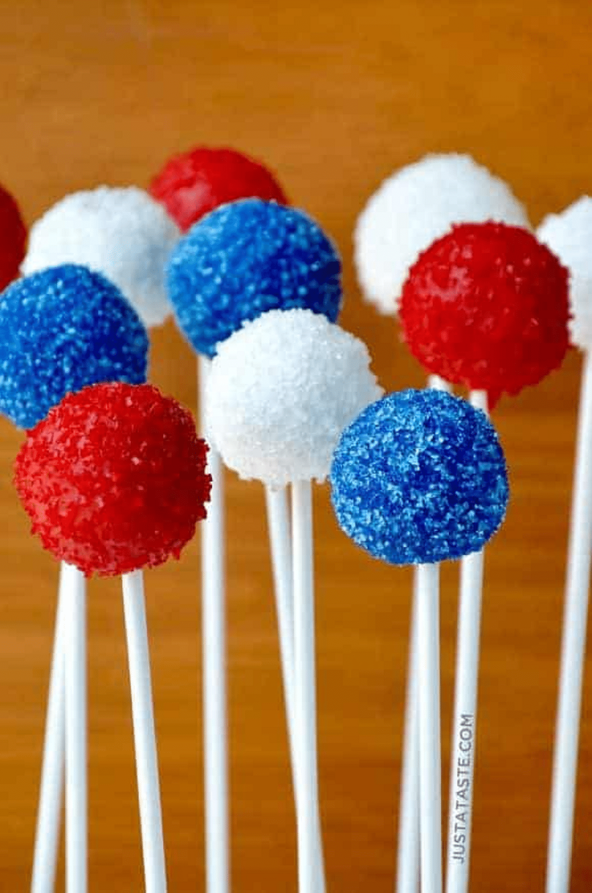 Red white and blue cake pops against wood wall