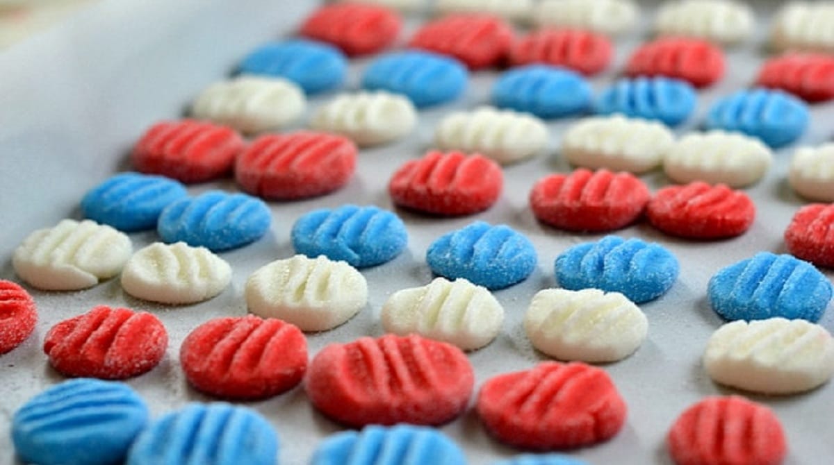 Rows of red white and blue rounds with indentations on top on tray
