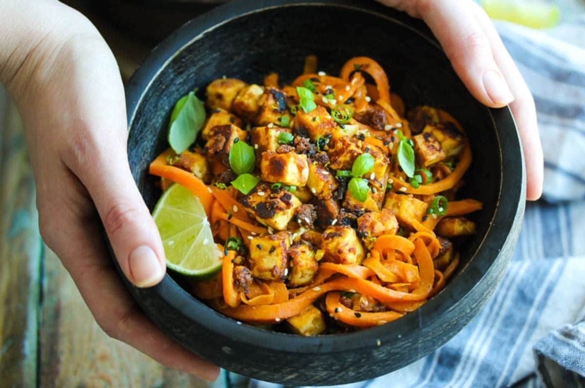 Sesame tofu coated in a sticky-sweet cashew sauce and tossed with sweet potato noodles. 