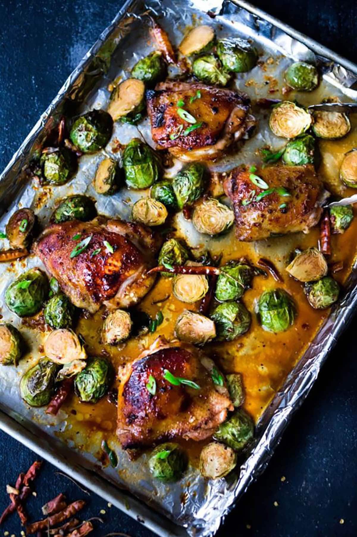 Sheet Pan Szechuan Chicken and Brussels Sprouts in a baking pan