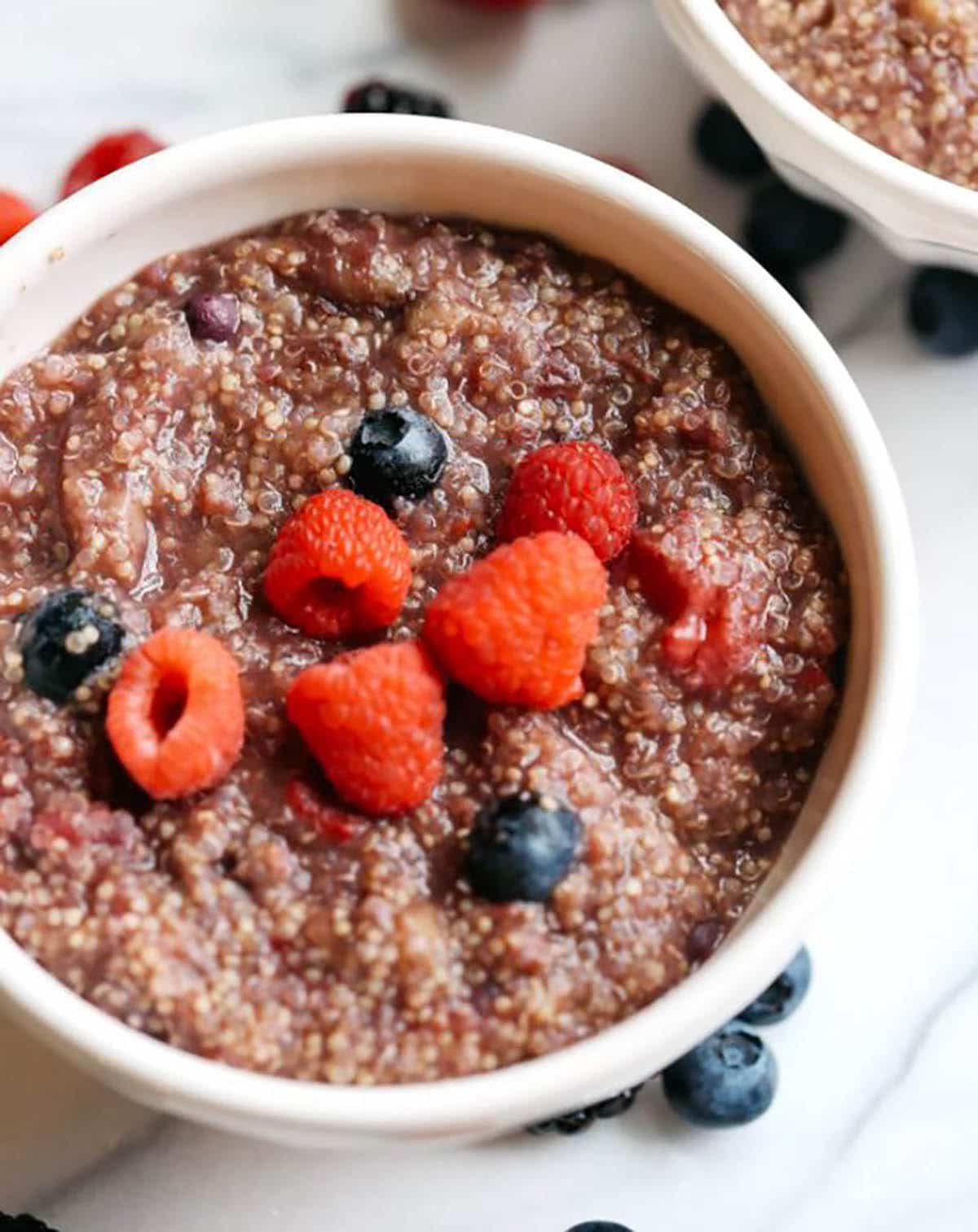 Slow Cooked Berry Breakfast Quinoa topped with blueberry and raspberry