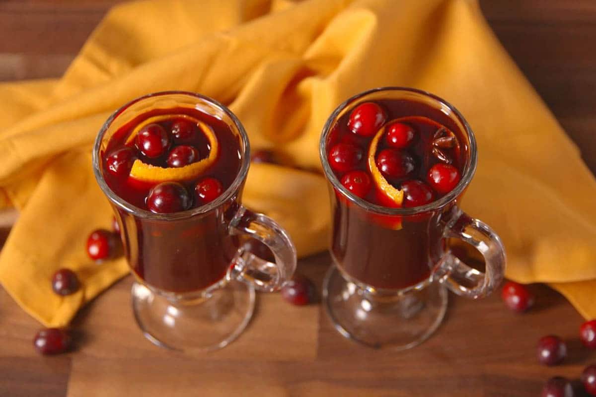 Slow Cooker Cranberry Mulled Wine with an orange peel and cranberries