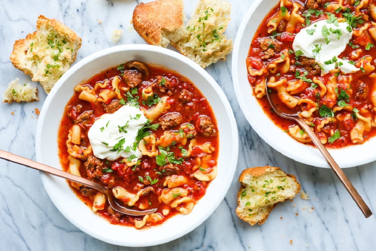 Lasagna Soup topped with chopped parsley and ricotta cheese