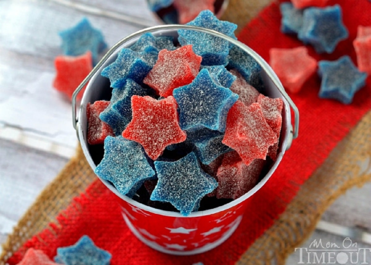 Mini red pail with white stars on red burlap filled with red and blue gummy stars