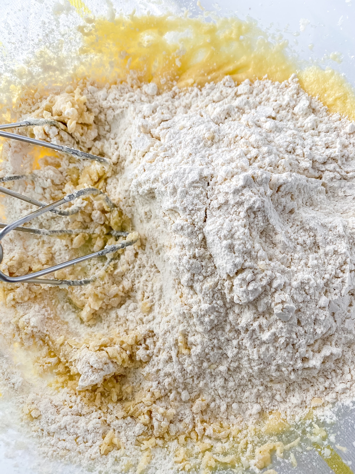 Batter with flour on top and whisk in side of bowl