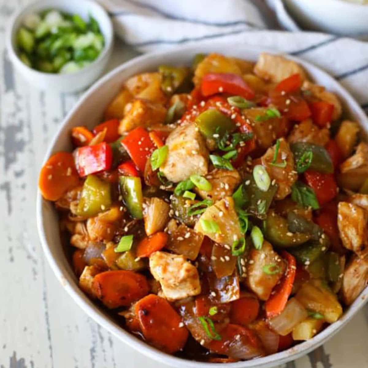 Sweet and Sour Chicken topped with spring onions 