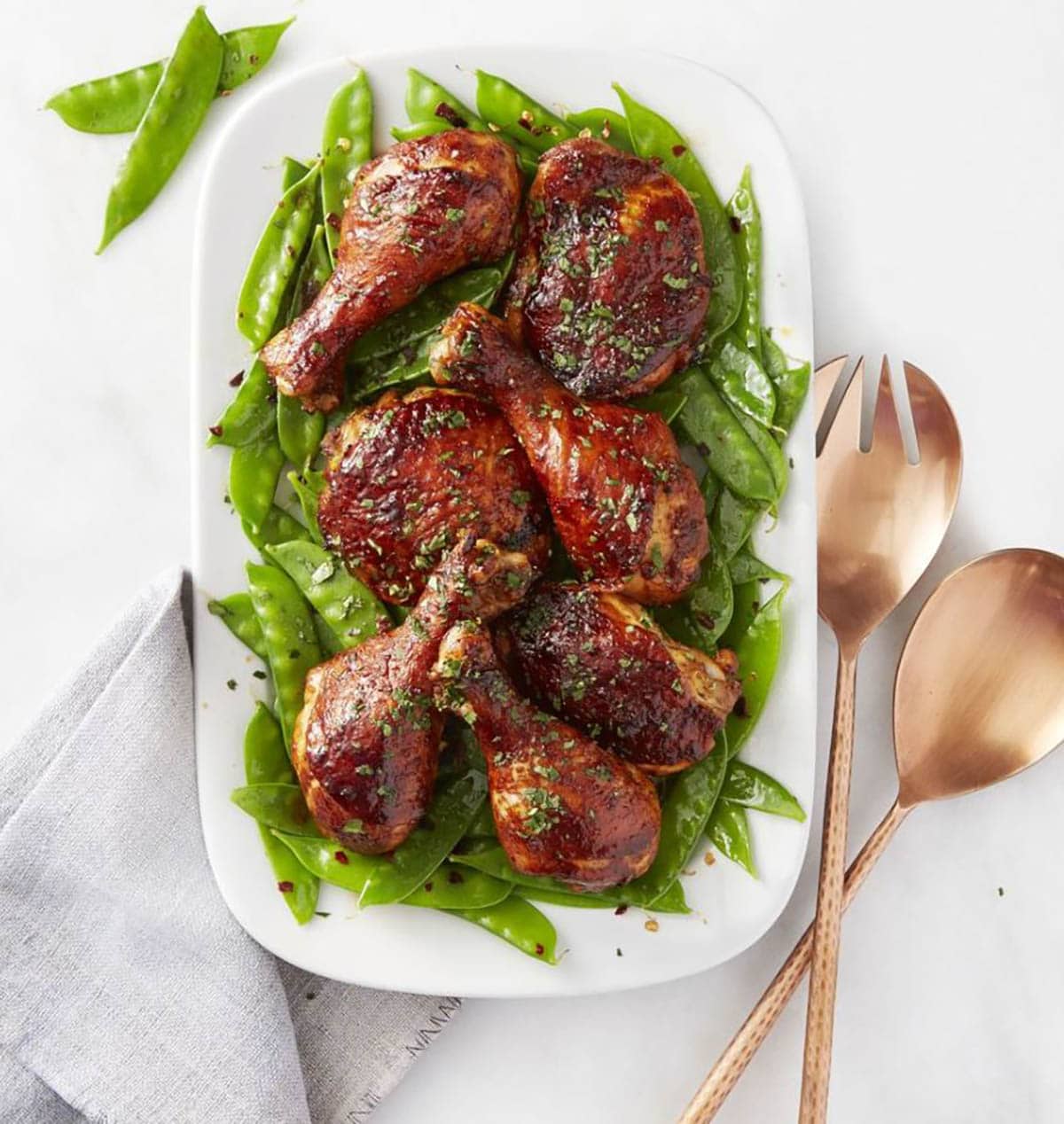 Sweet and Sticky Chicken with Snow Peas on a plate