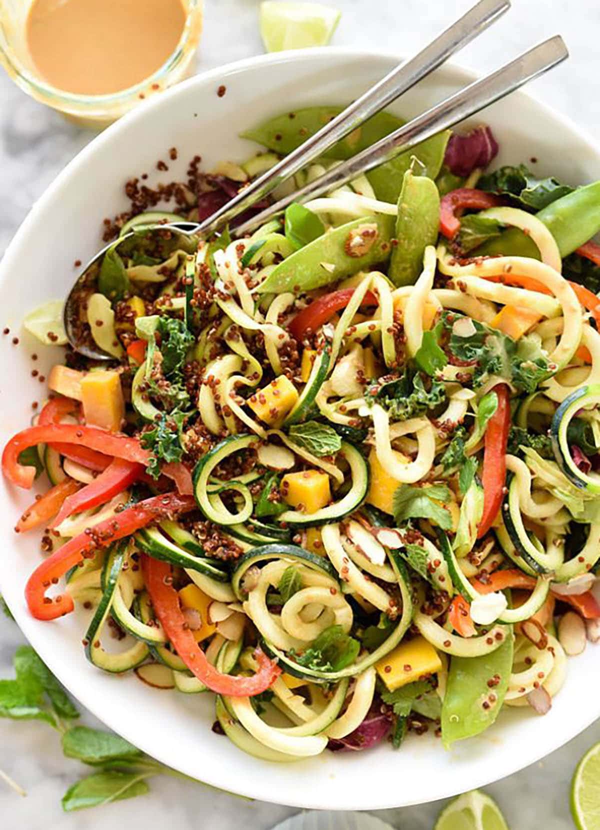 Thai Zucchini Noodle and Quinoa Salad Garnished with Almonds, Basil, Mint and Cilantro.