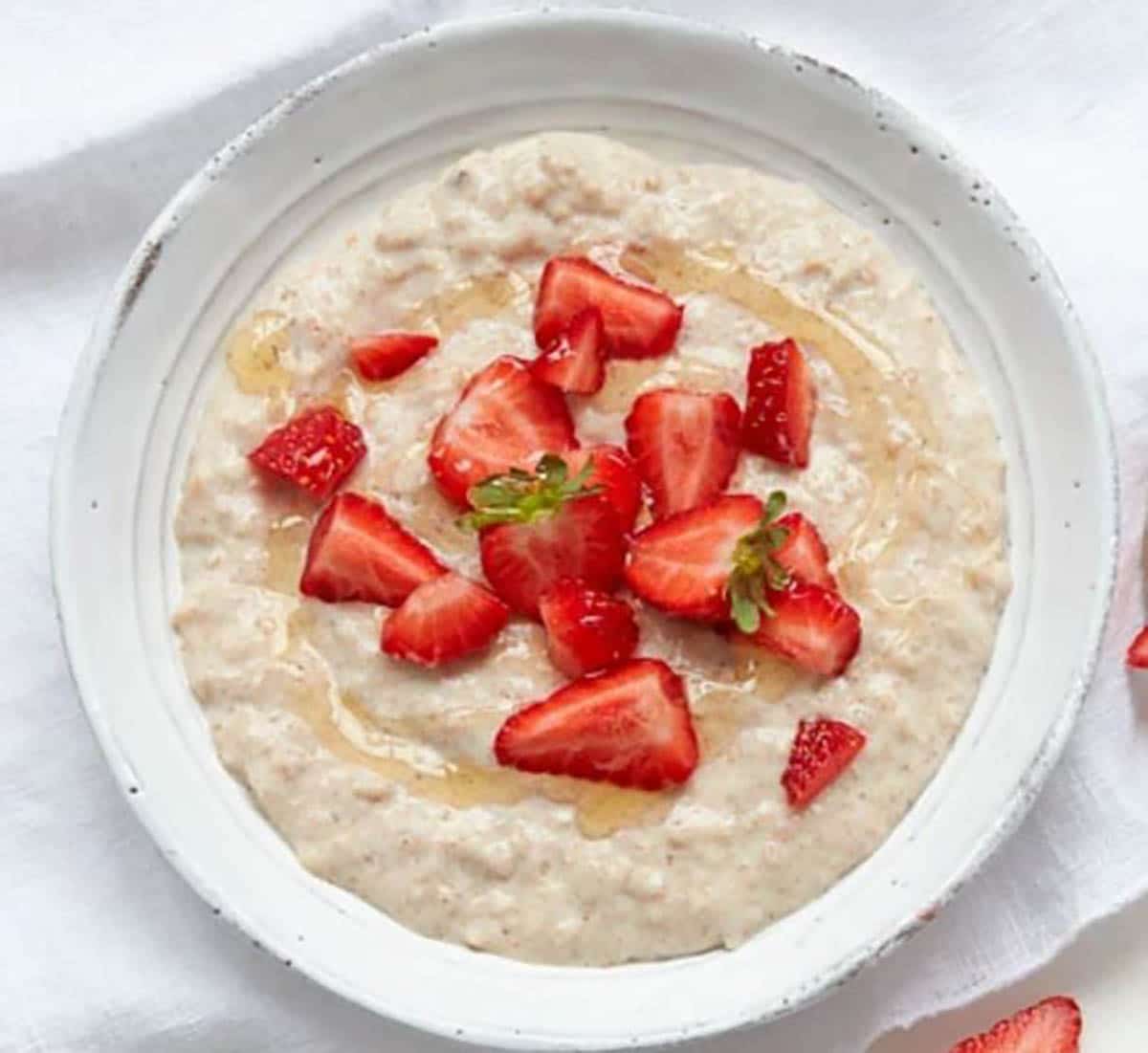 Three Grain Oatmeal topped with sliced strawberries