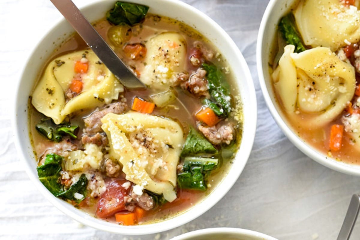 Bowls of Tortellini Soup With Sausage And Kale