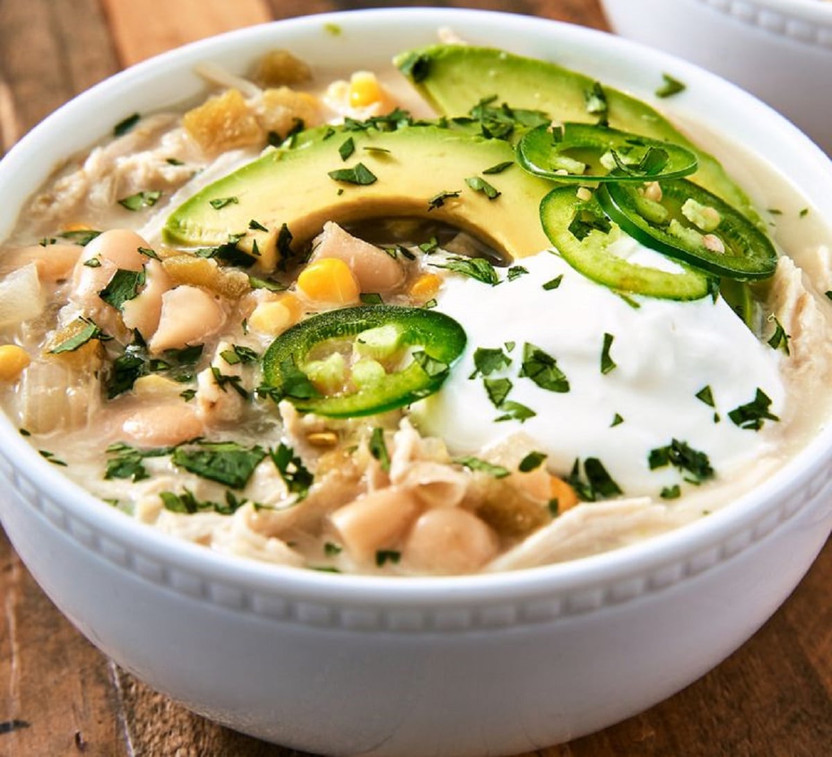 Chicken Chili topped with sliced avocado, jalapeno, coriander and sour cream