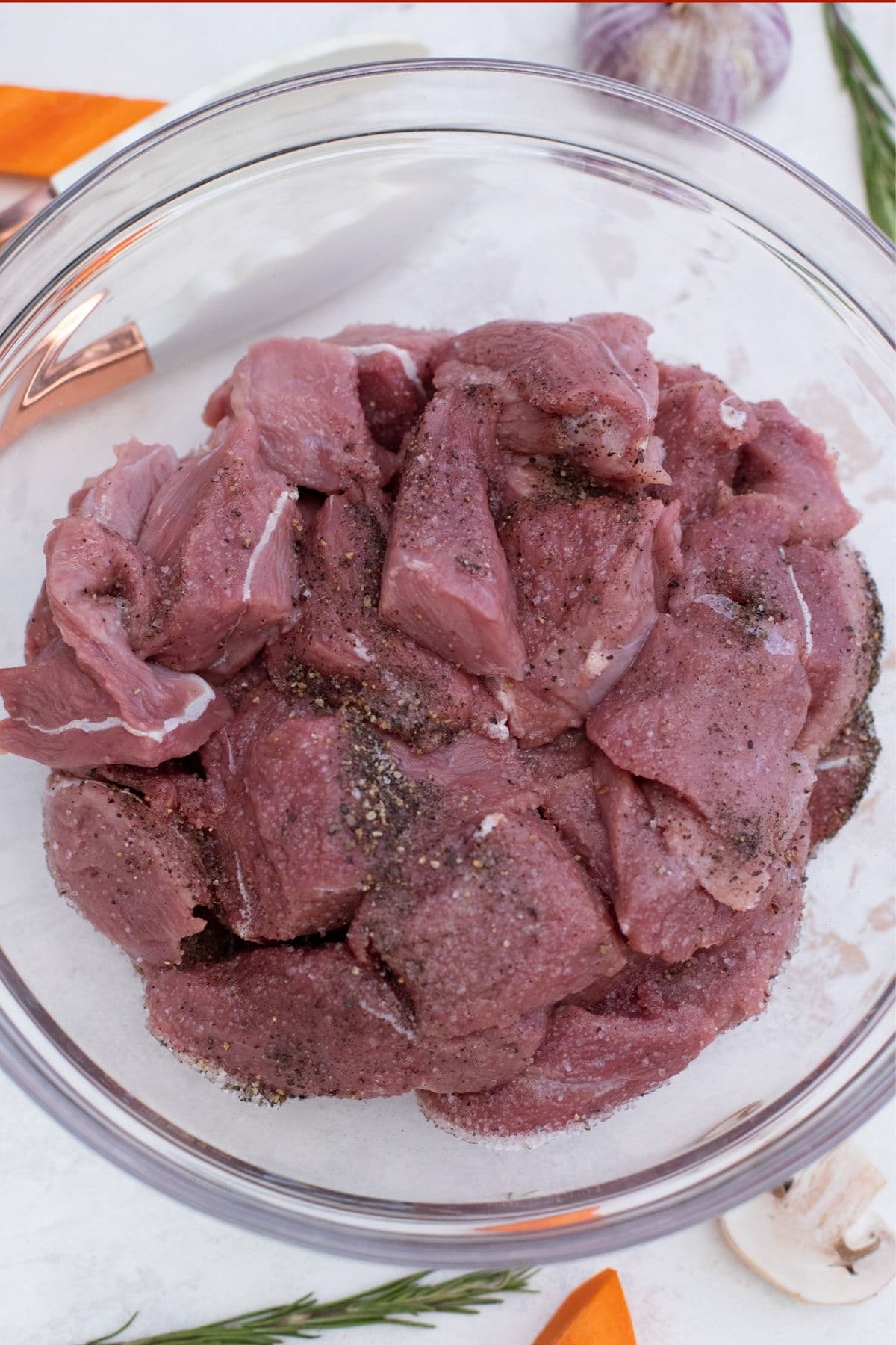 Chunks of beef in large glass bowl