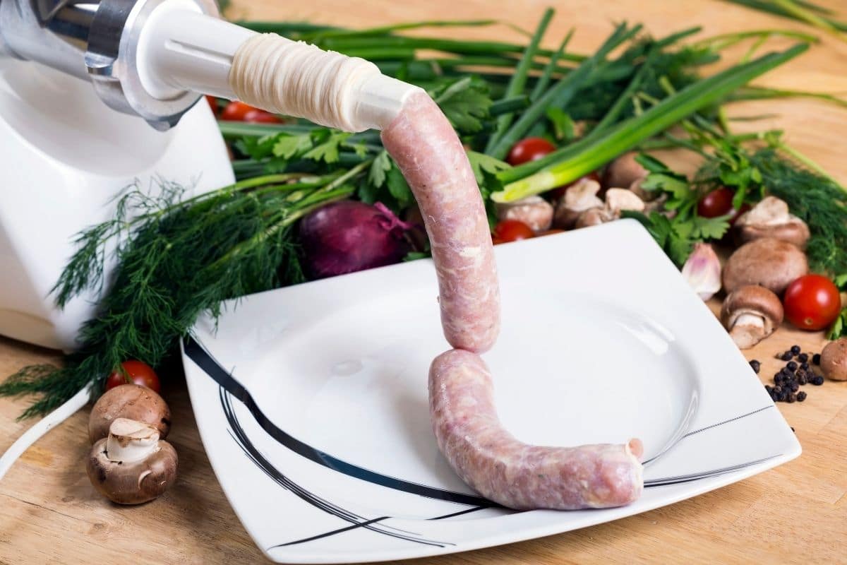 Sausages from White Sausage Stuffer to a White Plate