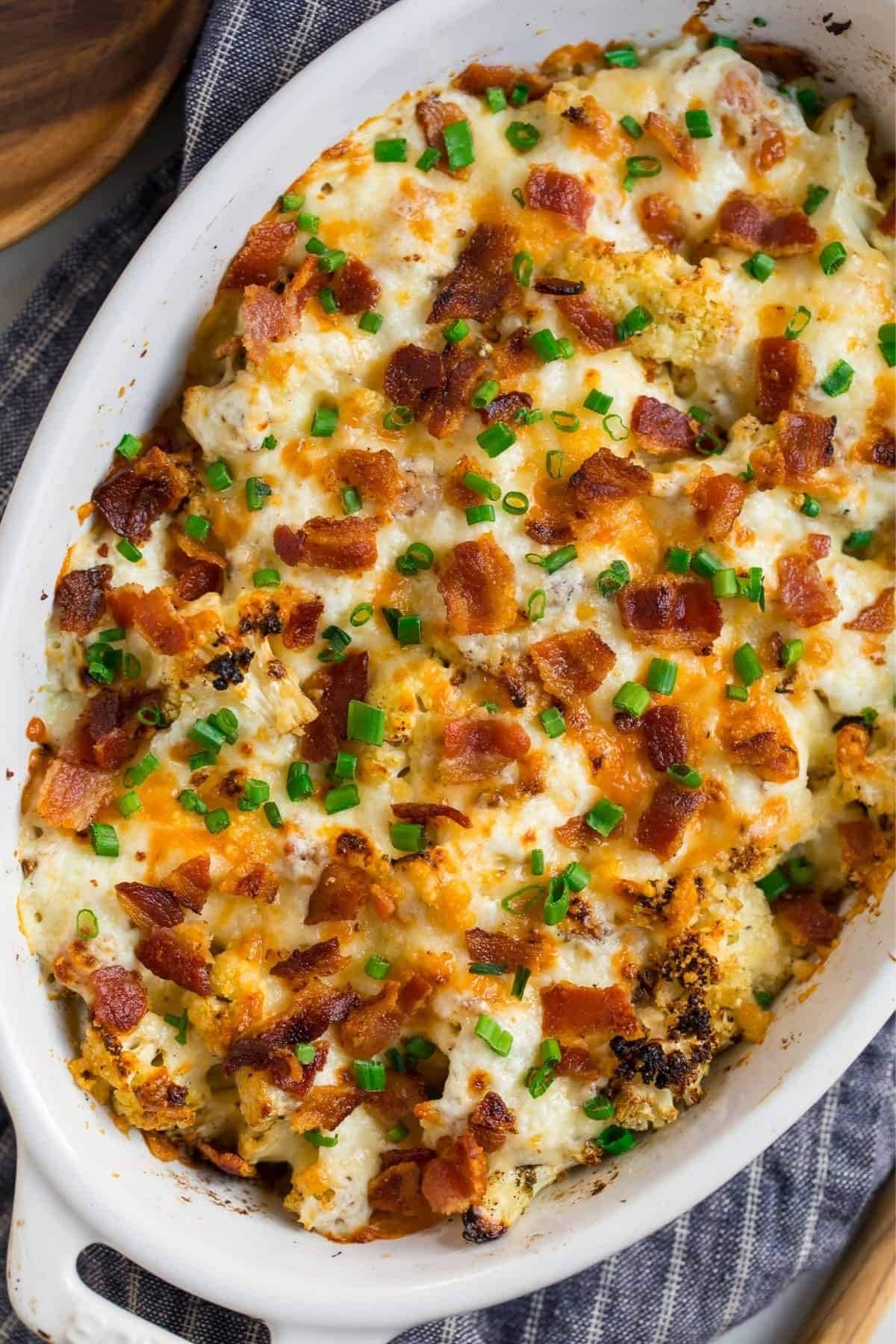 oval white casserole dish topped with browned cheese and chives
