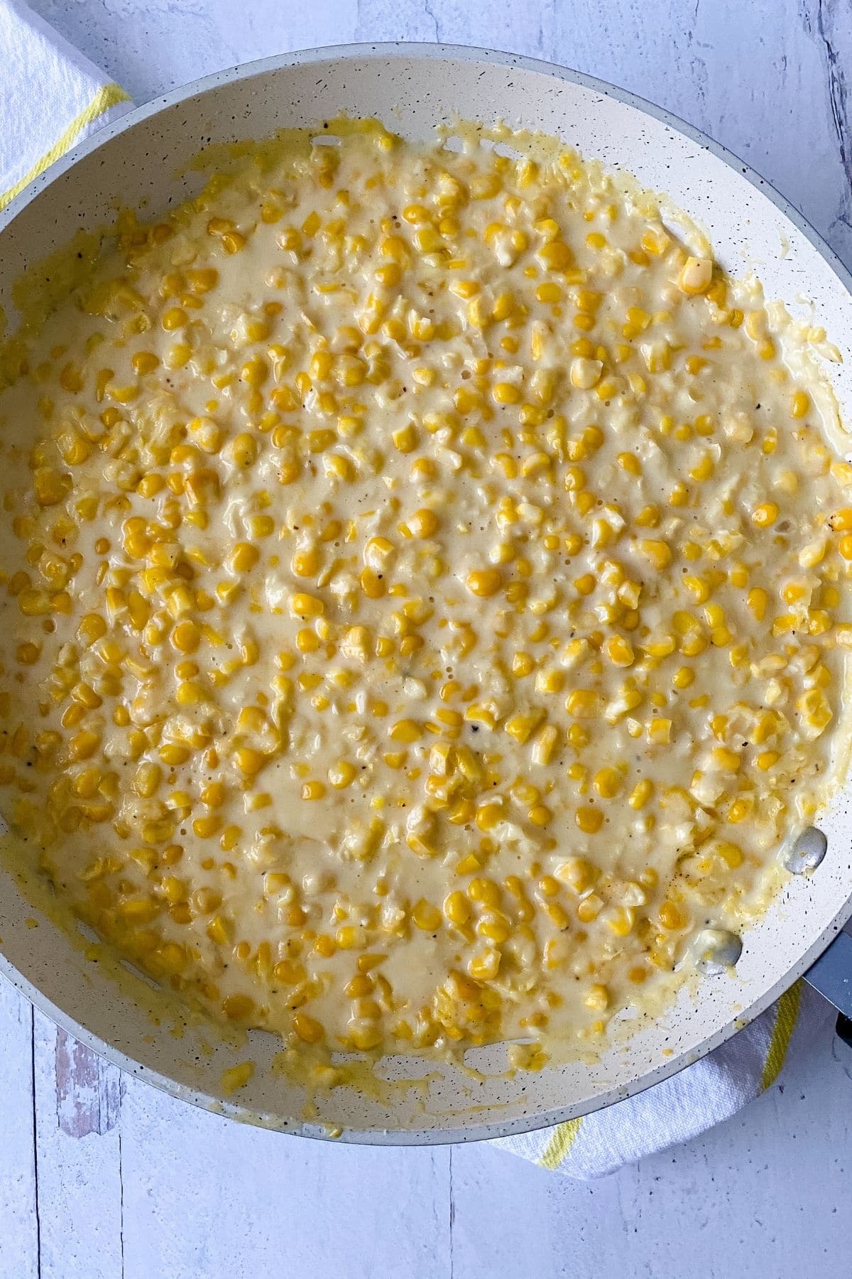 Creamed corn in large white skillet