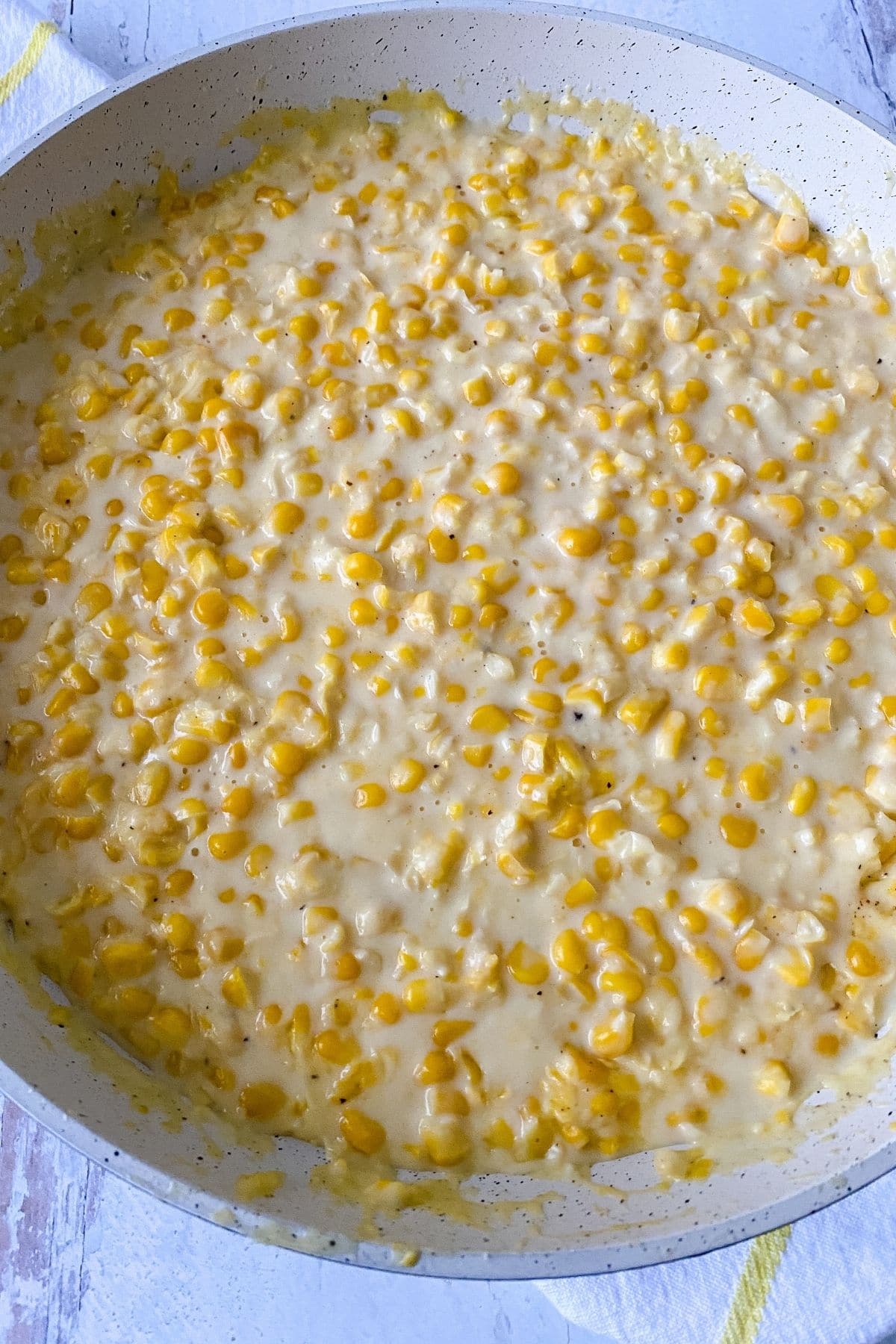 Skillet of creamed corn on table