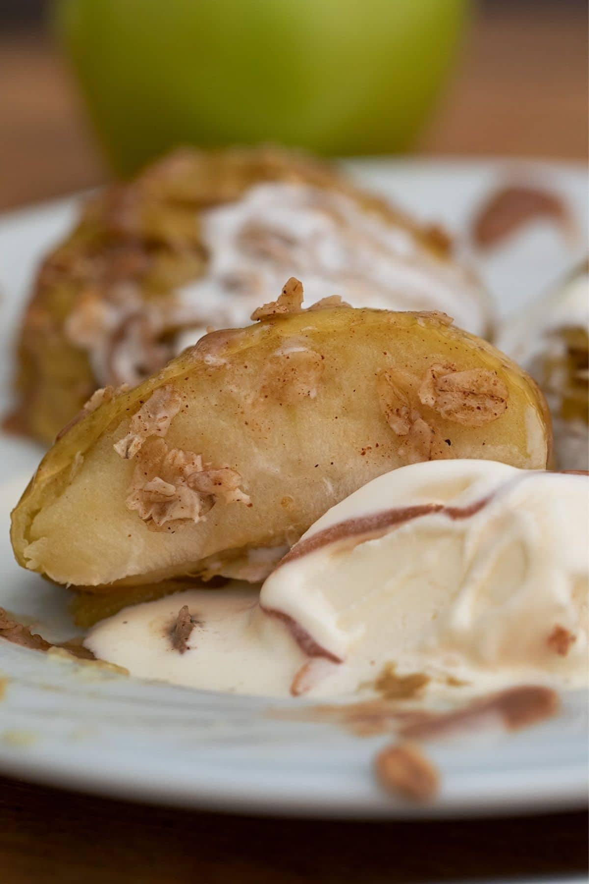 Side of baked apple on top of ice cream