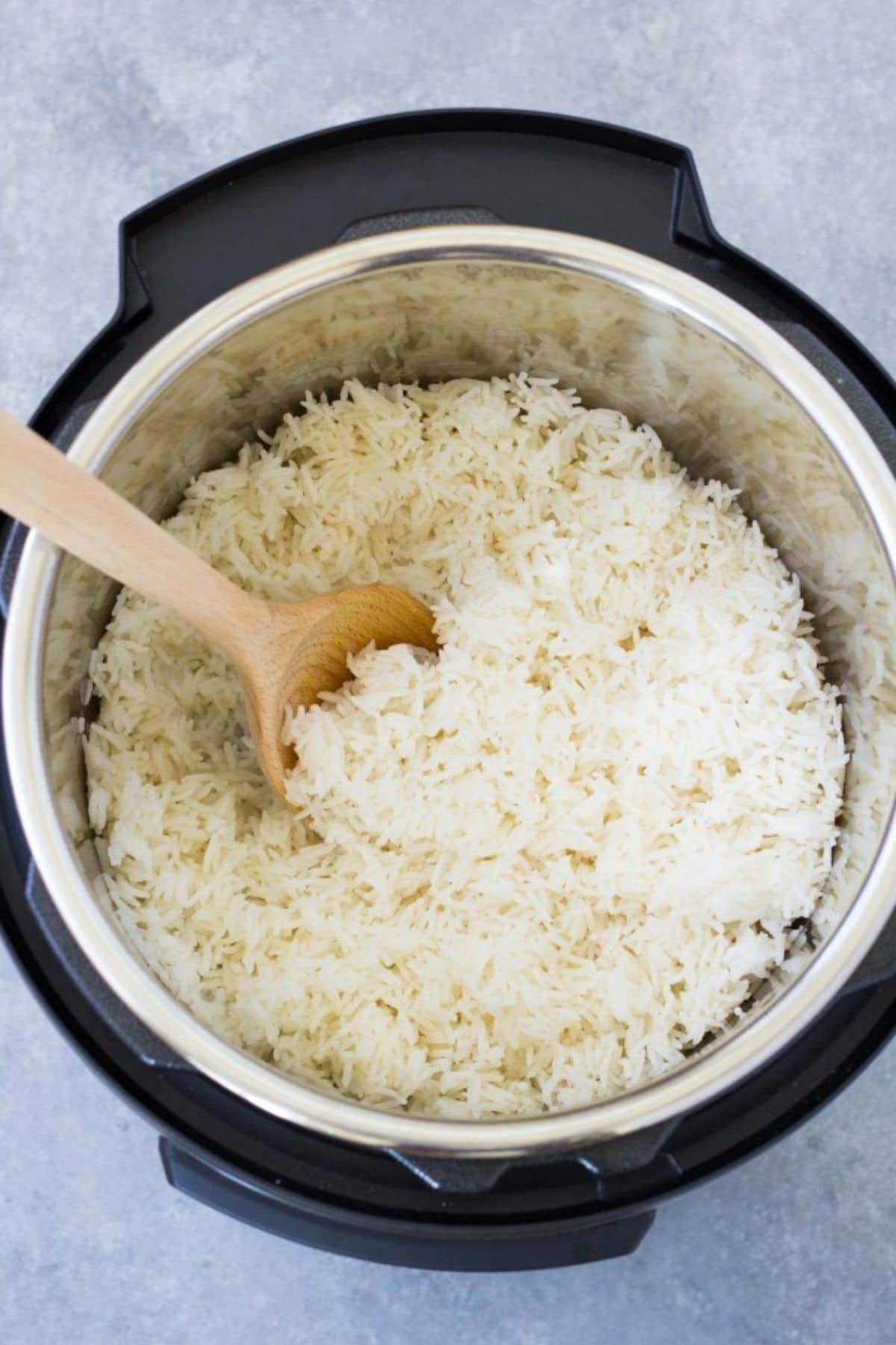 Instant pot of rice with wooden spoon