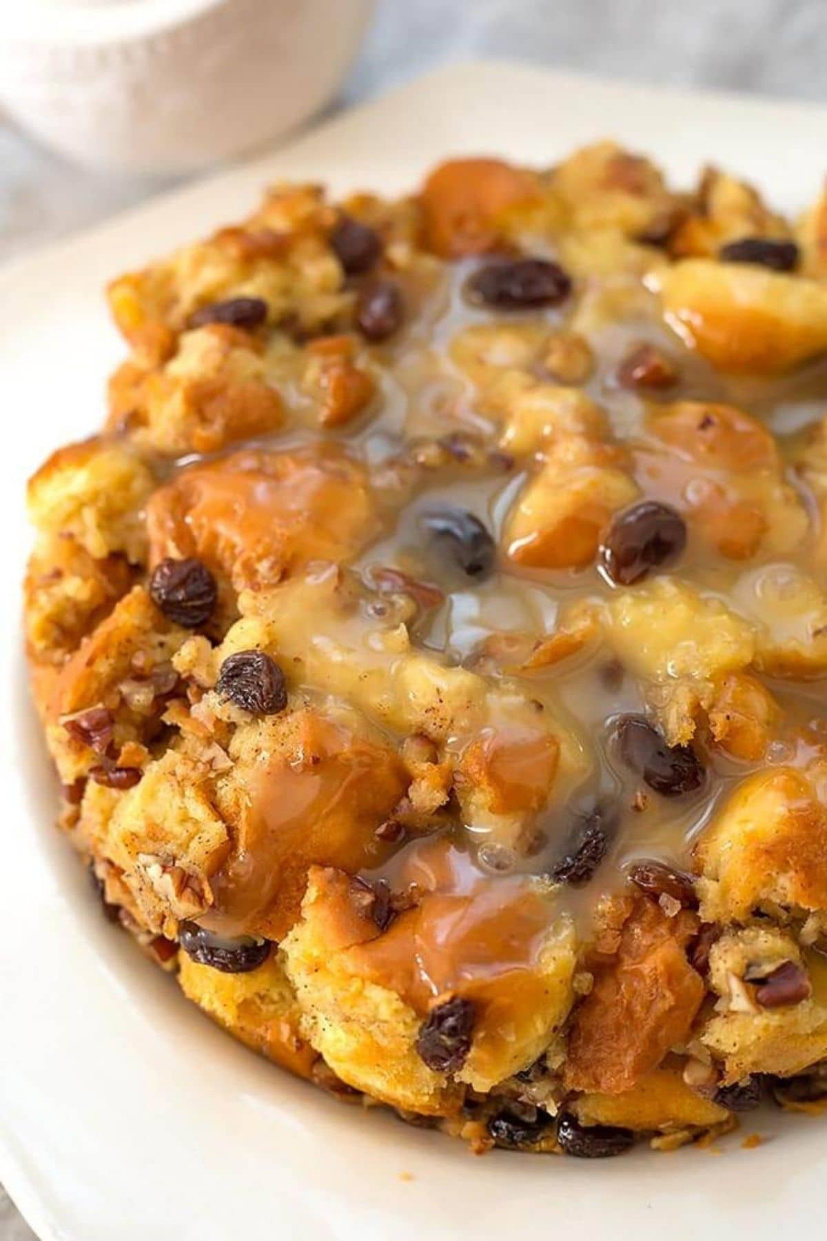 Bread pudding with raisins on white platter
