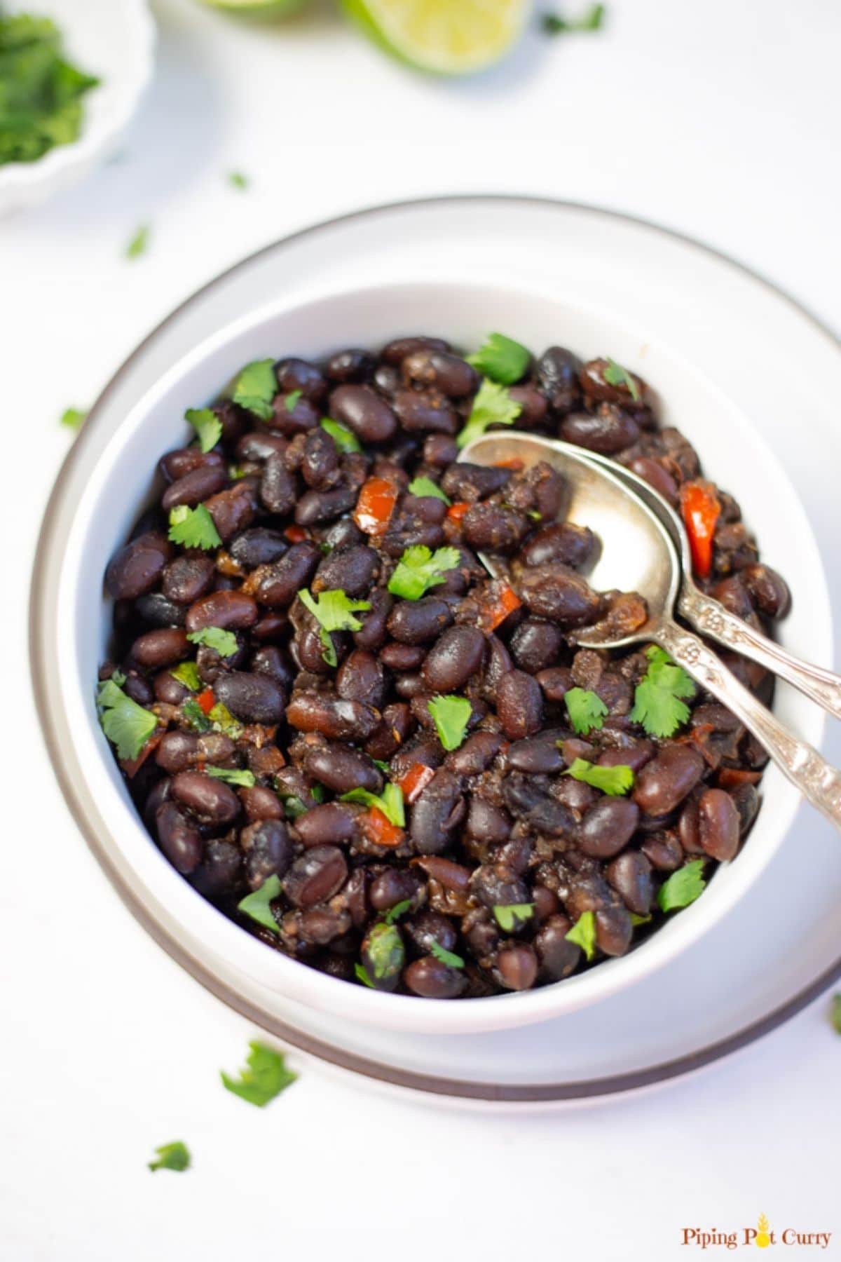Black beans with cilantro and pepper in white bowl