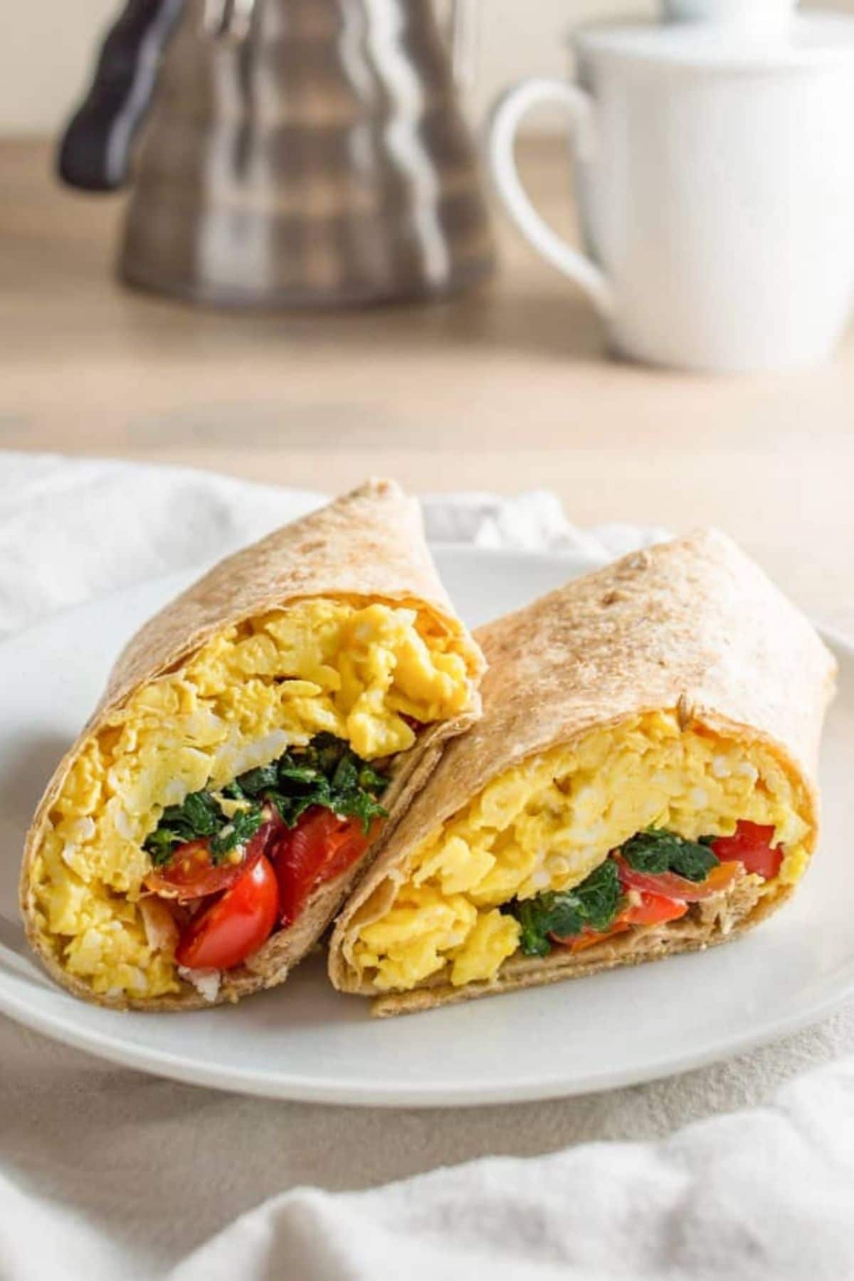 Egg and spinach inside tortilla on plate