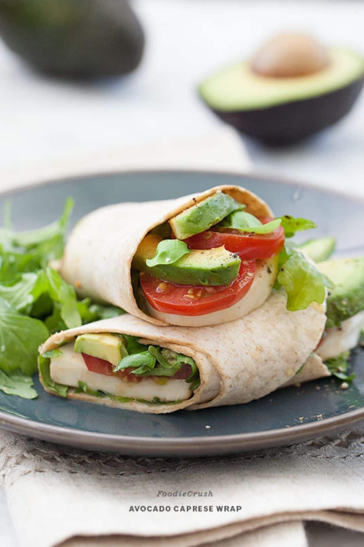 Tomato and avocado in wrap on gray plate