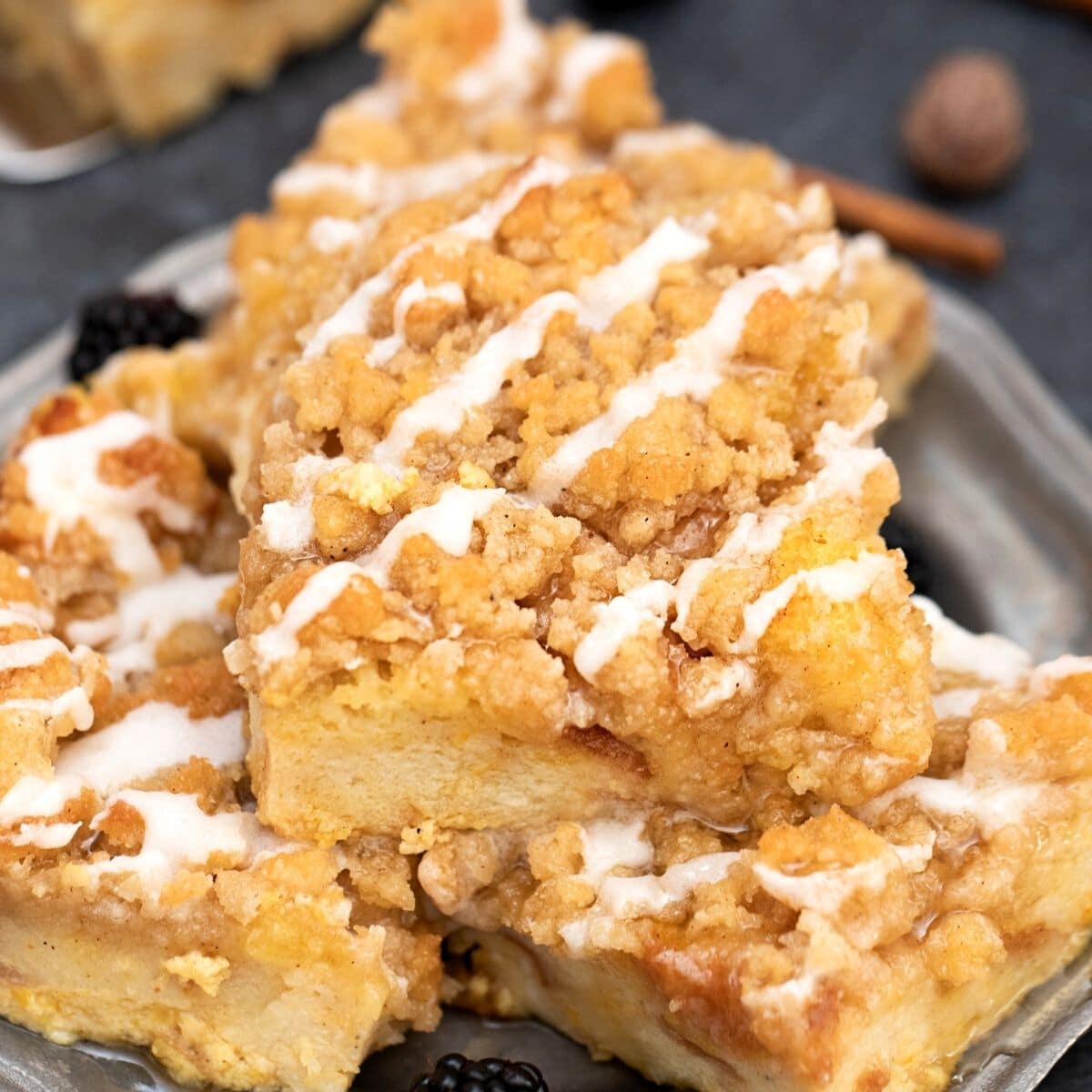 Squares of pumpkin spice french toast bake on black plate