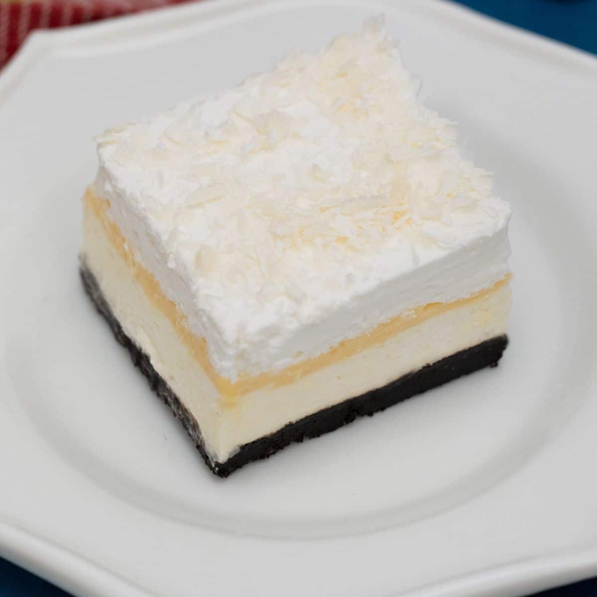 Slice of layered dessert on white plate