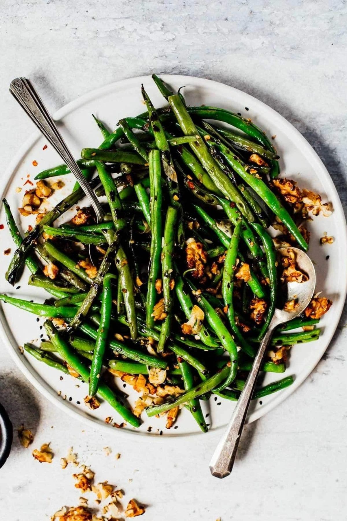 green beans on white plate on white table